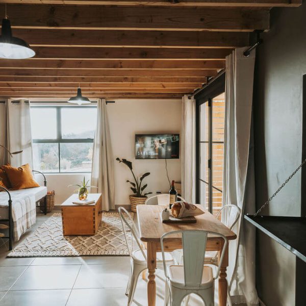 Living area with large windows overlooking countryside at De Stilte