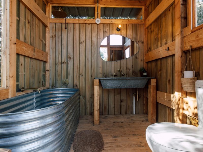 Ensuite bathroom with corrugated metal walls and basin