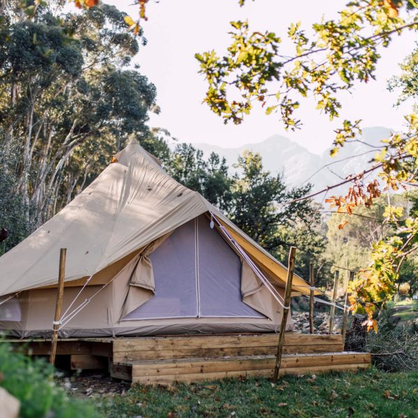 Bell tent with timber base on green lawn