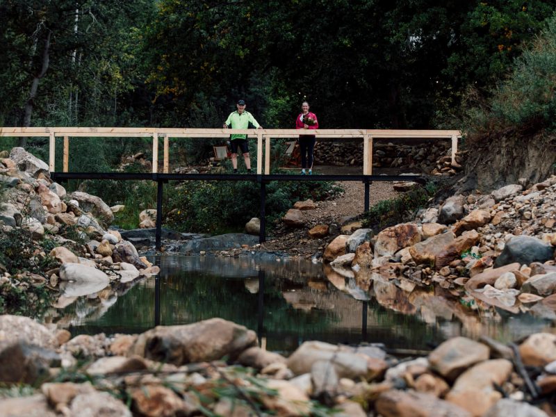 ootbridge over rocky stream with a guest crossing