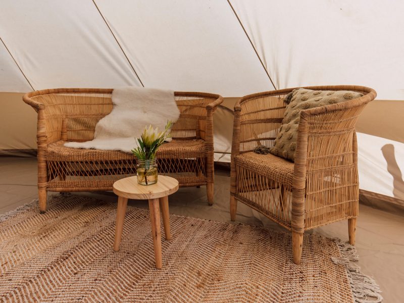 Wicker lounge nook with small table and potted plant