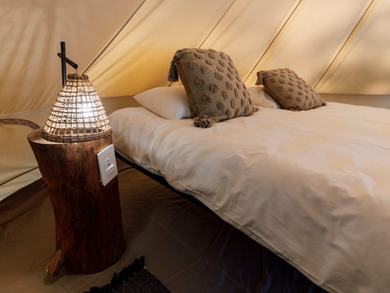 Luxury glamping bed setup at De Stilte